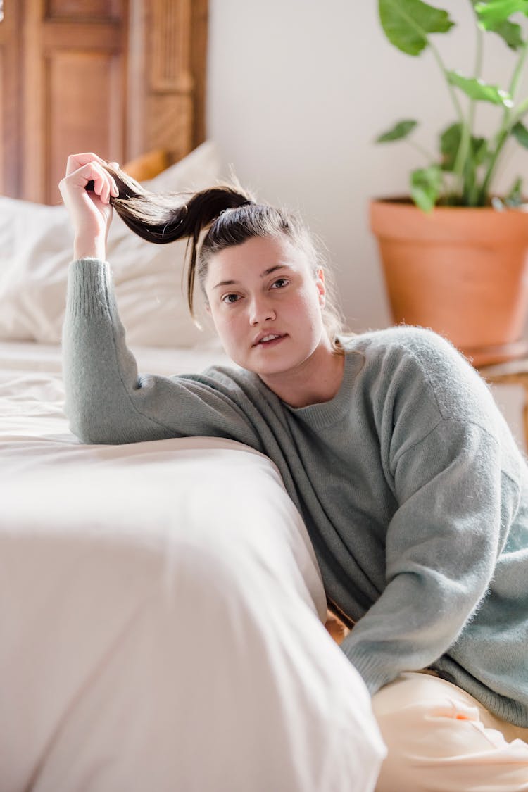 Young Woman With Ponytail In Hand