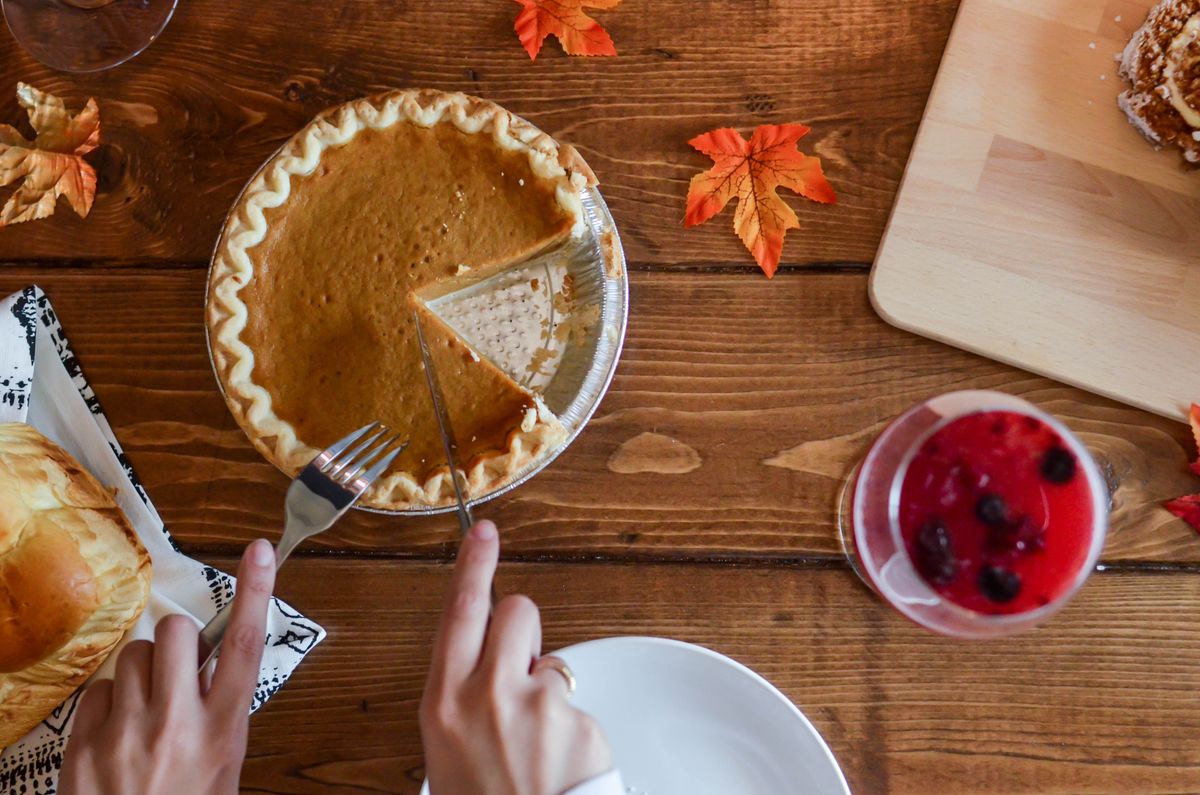 Bourbon pumpkin pie with pecan streusel on a wooden table