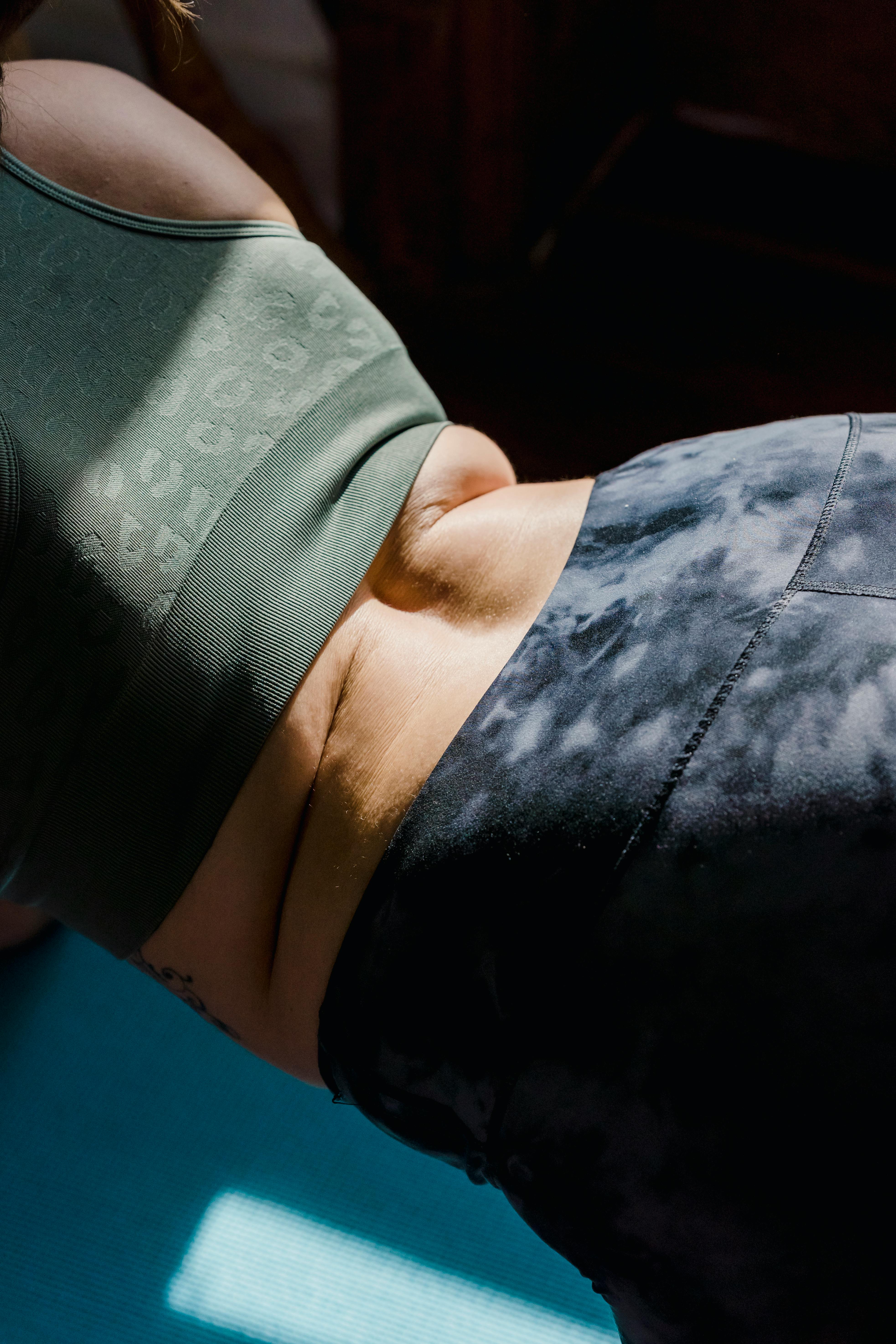 Empowering body positivity during a yoga session, showcasing natural skin and exercise wear.