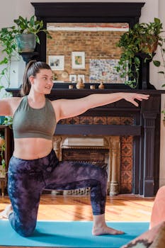 A woman practicing yoga in a cozy living room with natural light and plants.