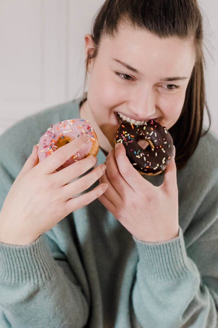 Happy Woman Eating Sweet Chocolate Donuts