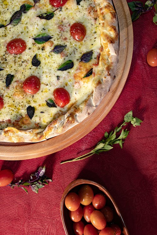 Free Cheesy Pizza in a Round Wooden Tray Stock Photo