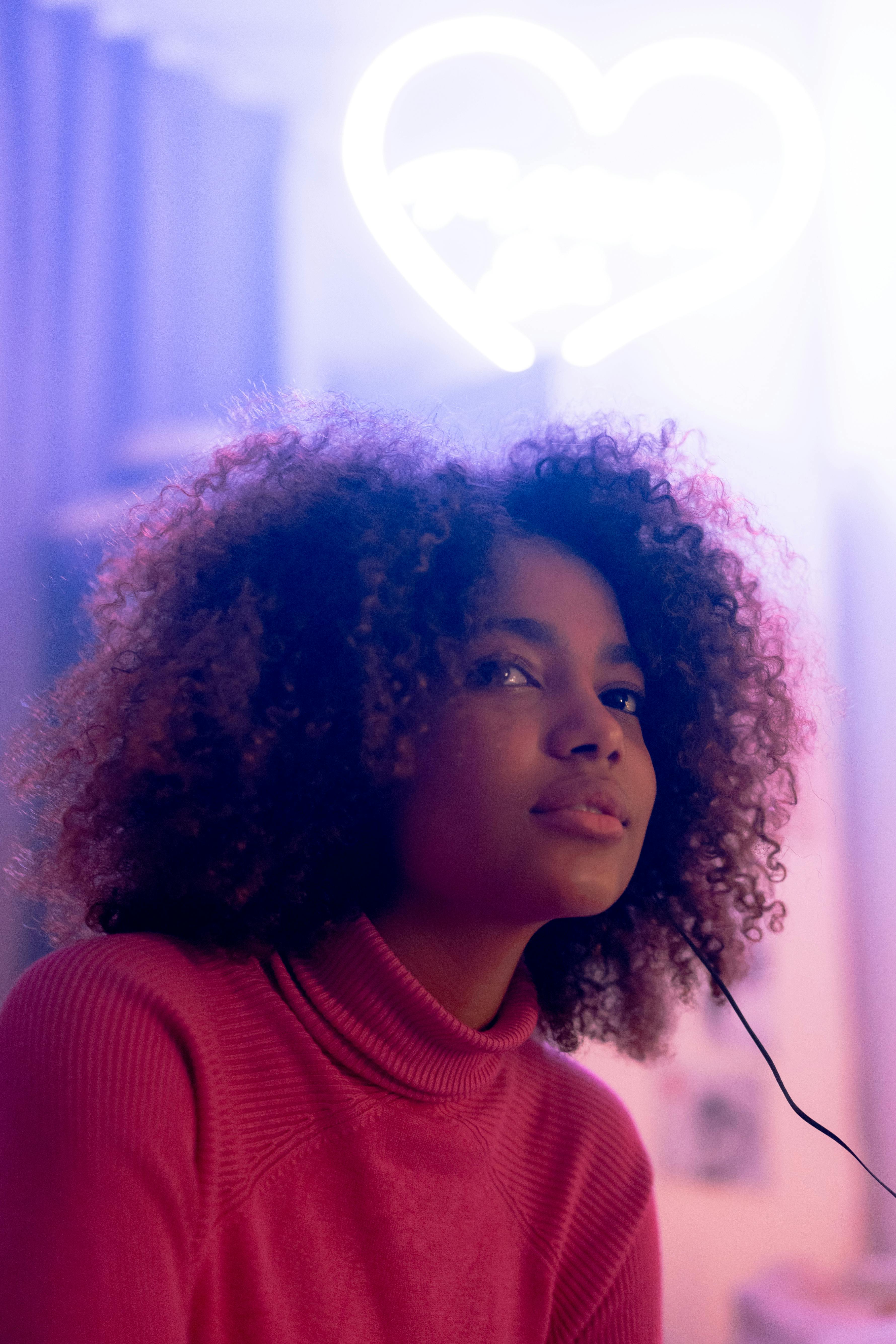 a portrait of a young woman in a red turtleneck sweater