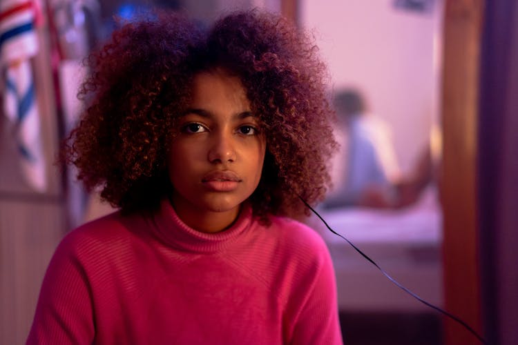 A Portrait Of A Young Woman In A Red Turtleneck Sweater