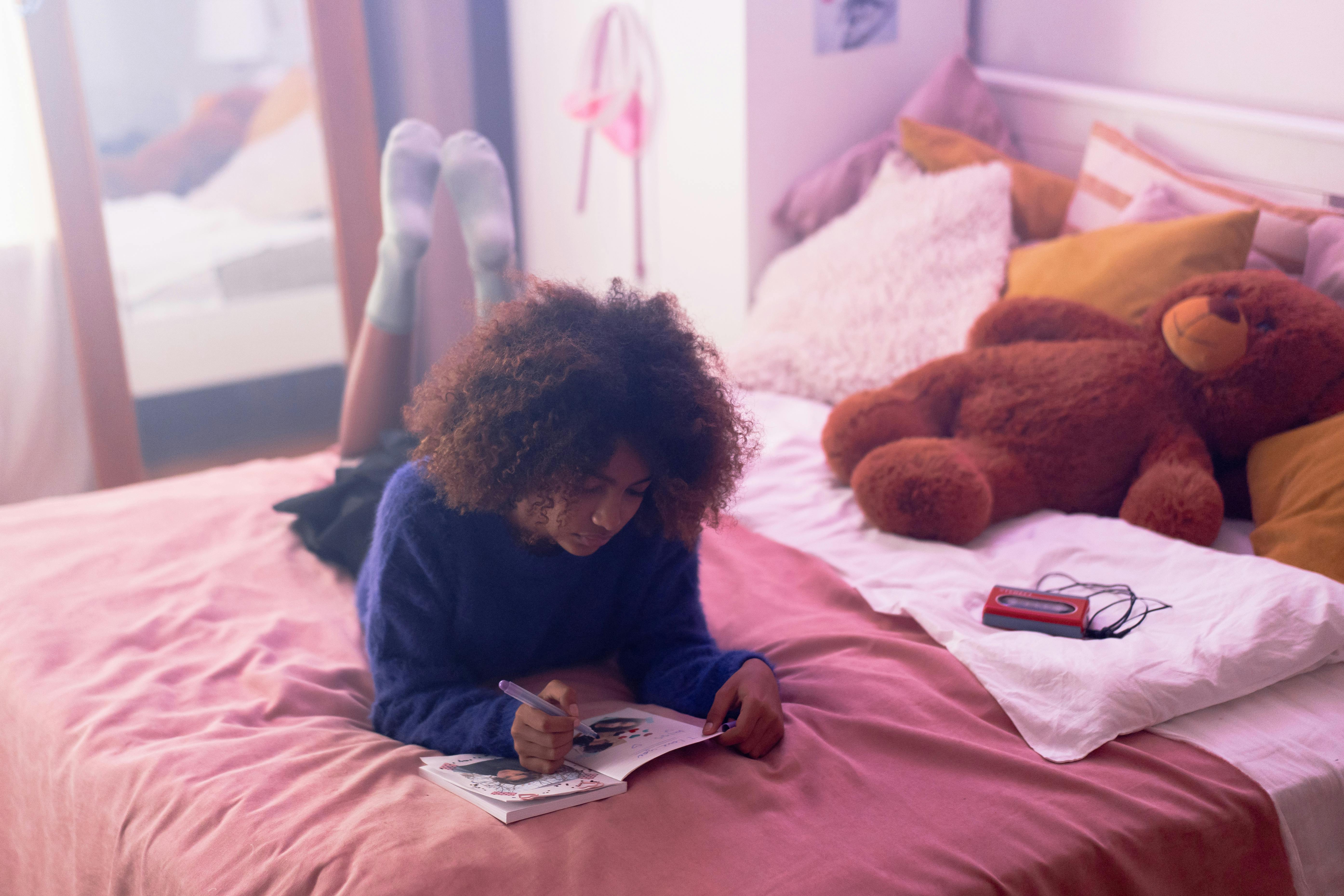 a woman writing on the book