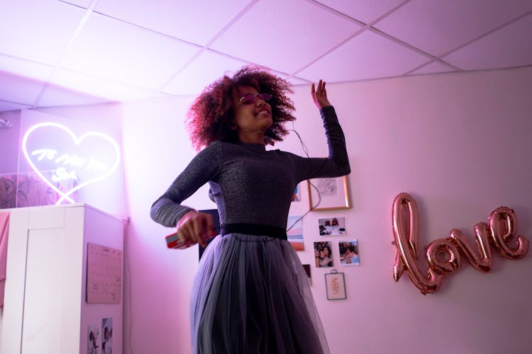 A Woman Listening Music While Dancing 