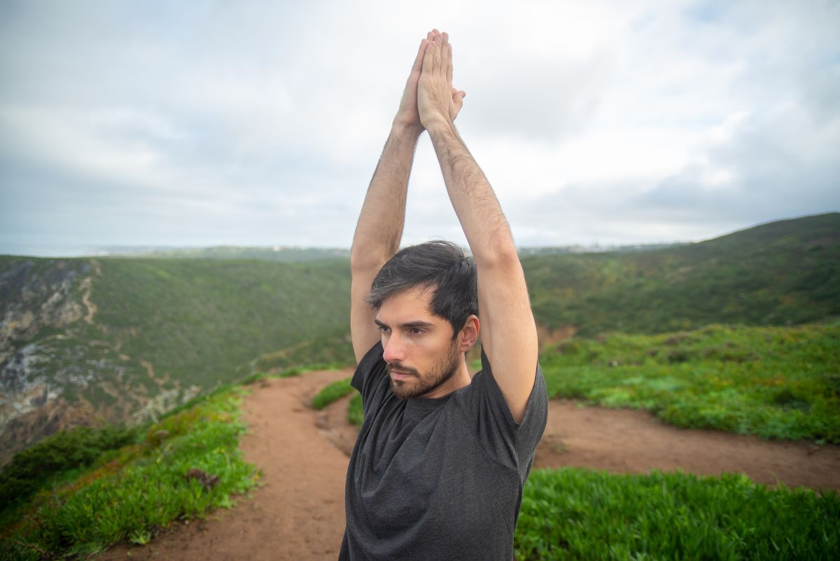 Man in a yoga pose outdoors