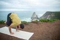 A Man in Yellow Shirt Doing Yoga