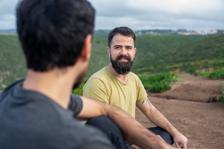 Men Meditating In Scenic Landscape