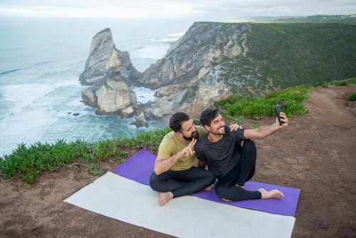 Men on Yoga Mats Outdoors Taking a Groupie