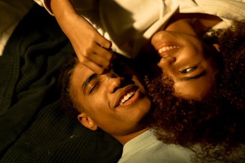 Free Young Woman Brushing Her Boyfriend Nose with a Feather Stock Photo