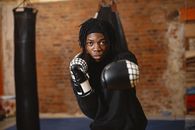 Woman in Black Leather Boxing Gloves