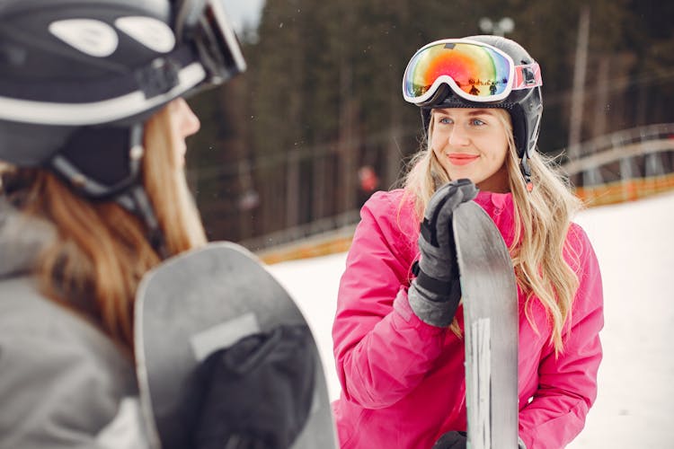 Women Standing With Snowboards