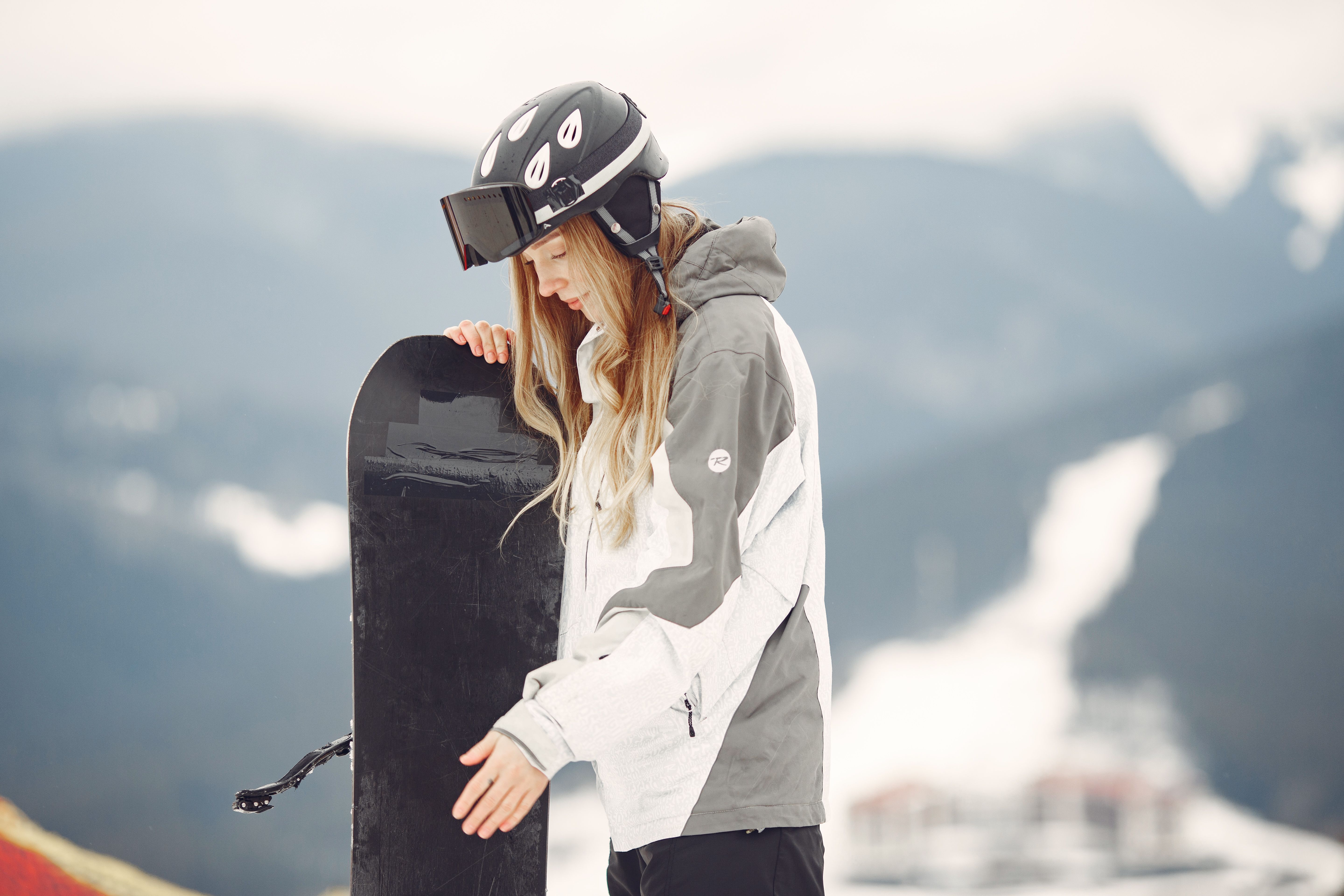 Female snowboarder enjoying fresh powder on the mountain