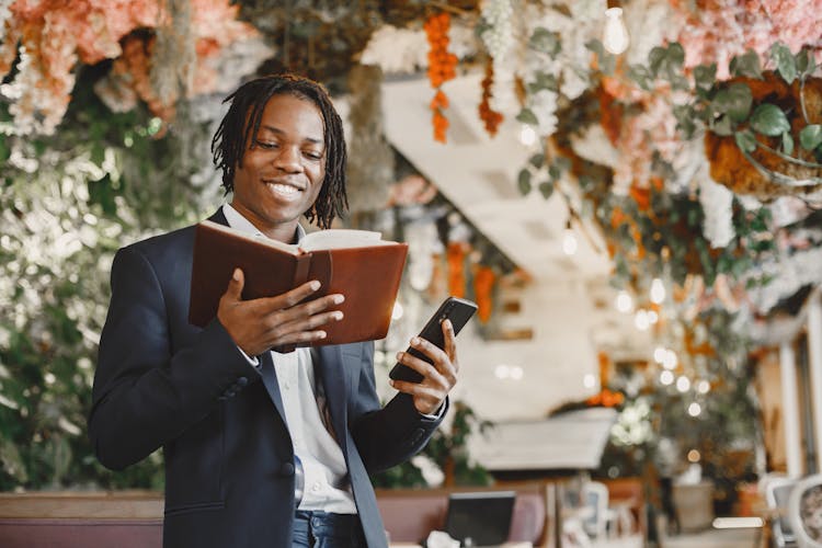 Man Holding Calendar And Smartphone