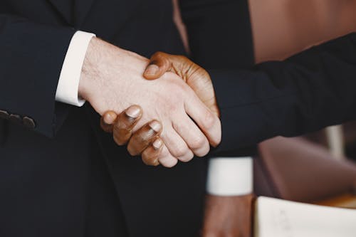 A Close-Up Shot of People Shaking Hands