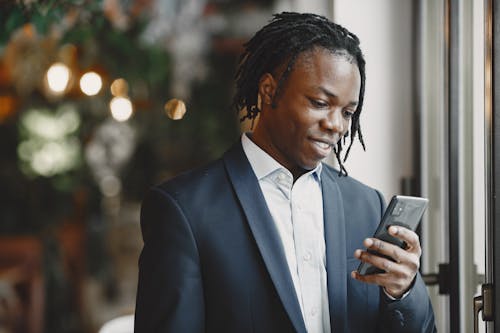 A Man Wearing a Corporate Attire Holding a Phone