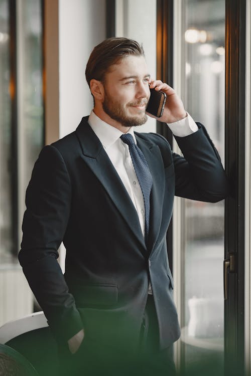 A Man Wearing a Corporate Attire Talking on a Phone