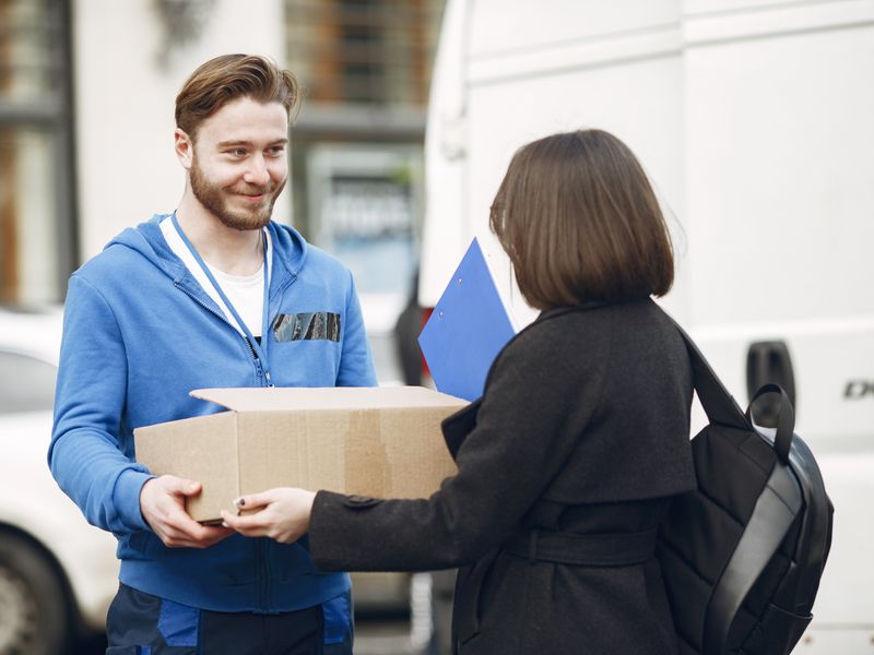 warehouse worker scanning package for shipping