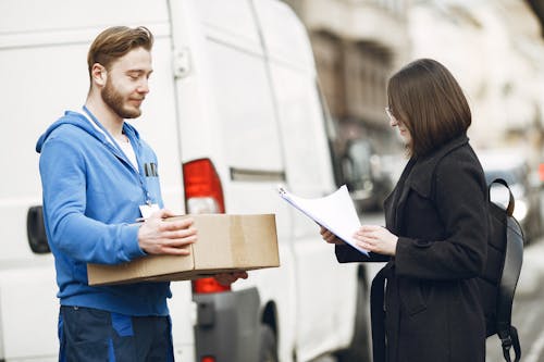 Deliveryman Giving Package to Client