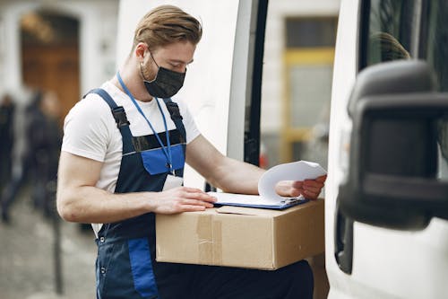 Man in Face Mask Delivering Packages