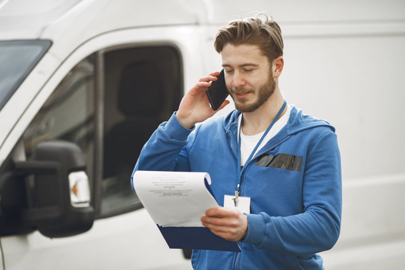 Professional plumber on the phone with clipboard