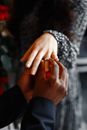A Man Putting on a Ring Into a Woman's Finger