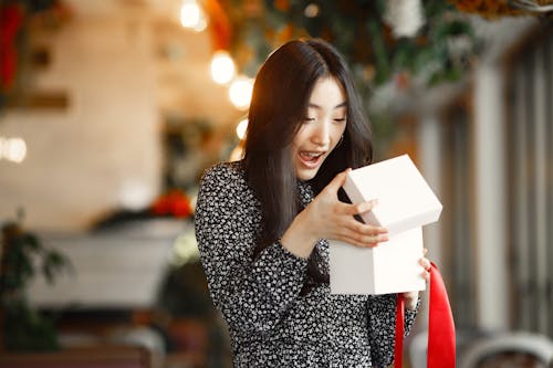 A Woman Opening a Gift Box