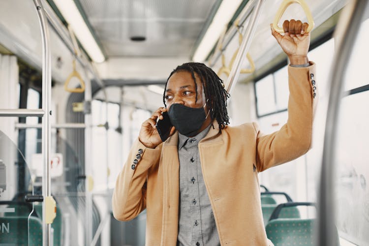 Man In Bus Talking On Phone