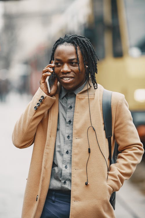 Portrait of a Young Man in City Talking Through a Phone 