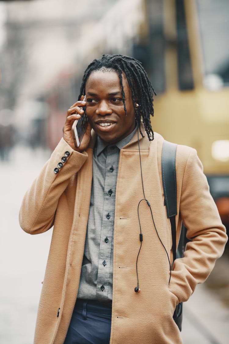 Portrait Of A Young Man In City Talking Through A Phone 