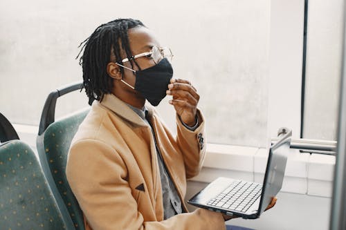 Free A Man Holding a Laptop Stock Photo