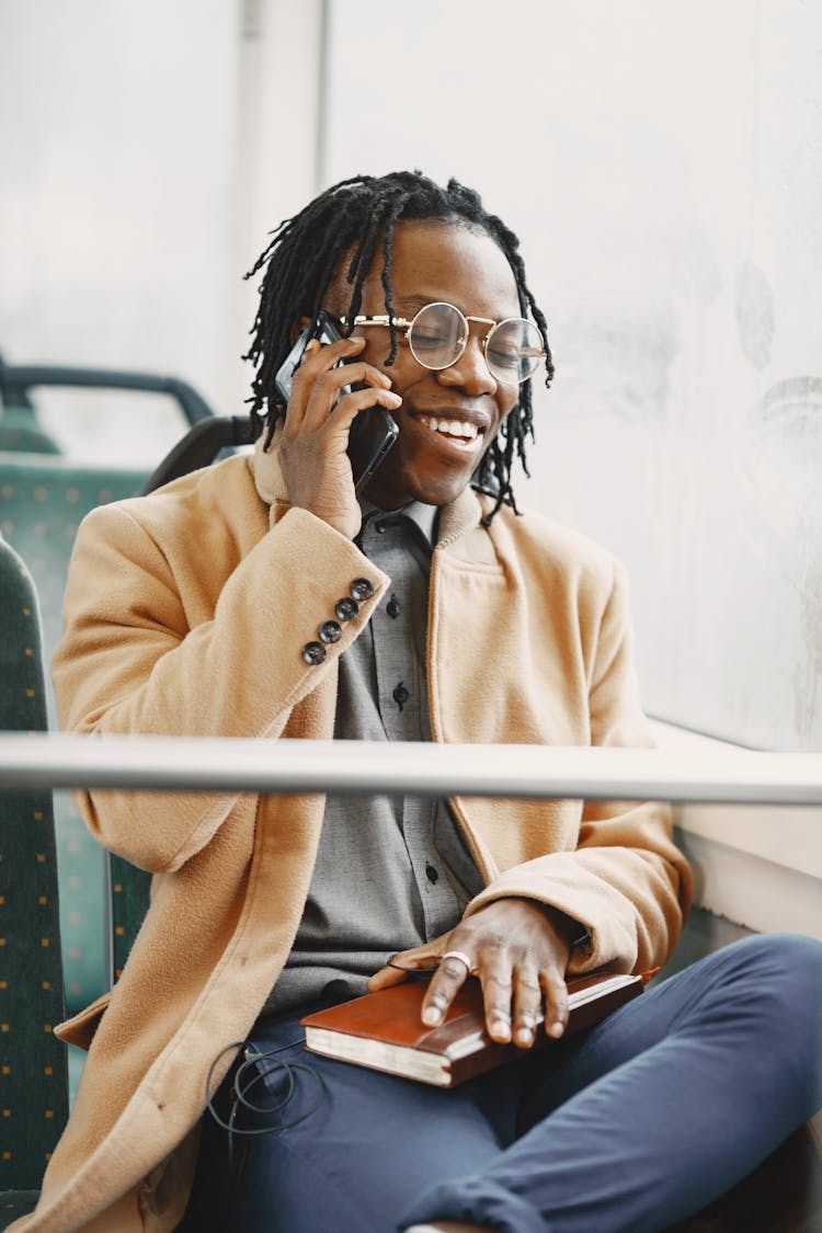 Smiling Man In Bus Talking On Phone