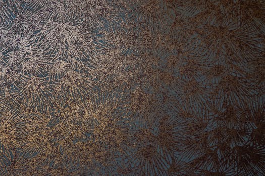 A textured abstract design featuring metallic accents on a dark background, ideal for artistic decor.