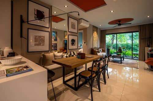 Free Stylish open dining area with wooden table and modern decor in bright living room. Stock Photo