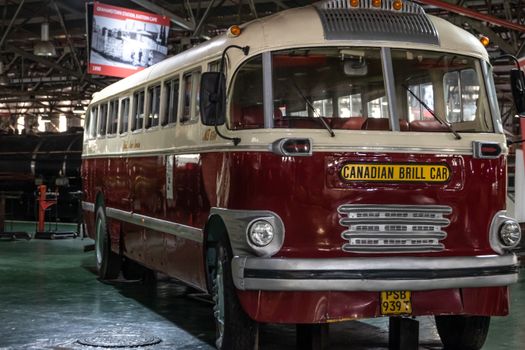 Classic Canadian Brill bus parked inside a vintage vehicle garage. Ideal for history enthusiasts.
