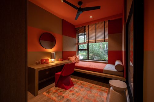 Free A stylish bedroom with vibrant orange decor and unique furnishings creating a cozy and inviting atmosphere. Stock Photo