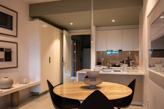 Contemporary dining area with stylish decor and ambient lighting for home comfort.