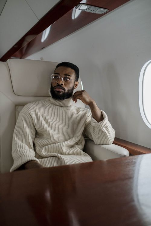 Free A fashionable man in a luxury private jet, enjoying a peaceful flight. Stock Photo