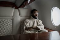 Man in White Sweater Sitting on White Leather Couch