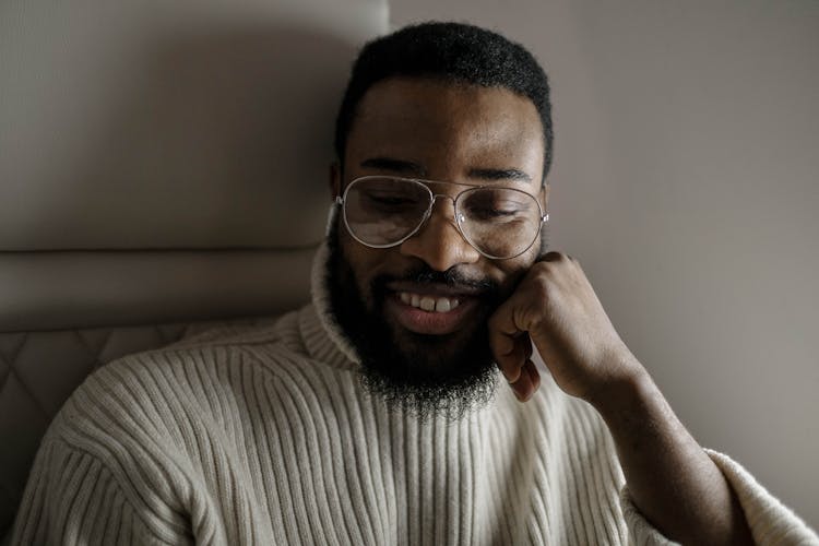 A Happy Man In Turtleneck Sweater Wearing Eyeglasses