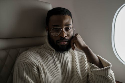 A Man in Turtleneck Sweater Seriously Looking at the Camera