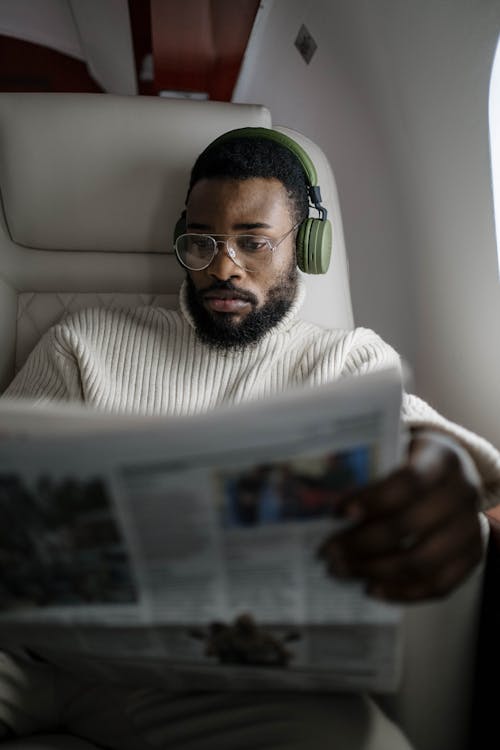 Free Man in White Long Sleeve Shirt Reading Newspaper Stock Photo