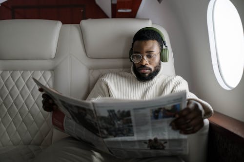 Free A Man with Eyeglasses Reading a Newspaper Stock Photo