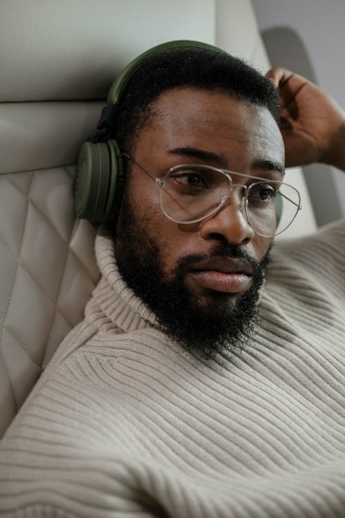 Free Man in White and Black Striped Shirt Wearing Black Headphones Stock Photo