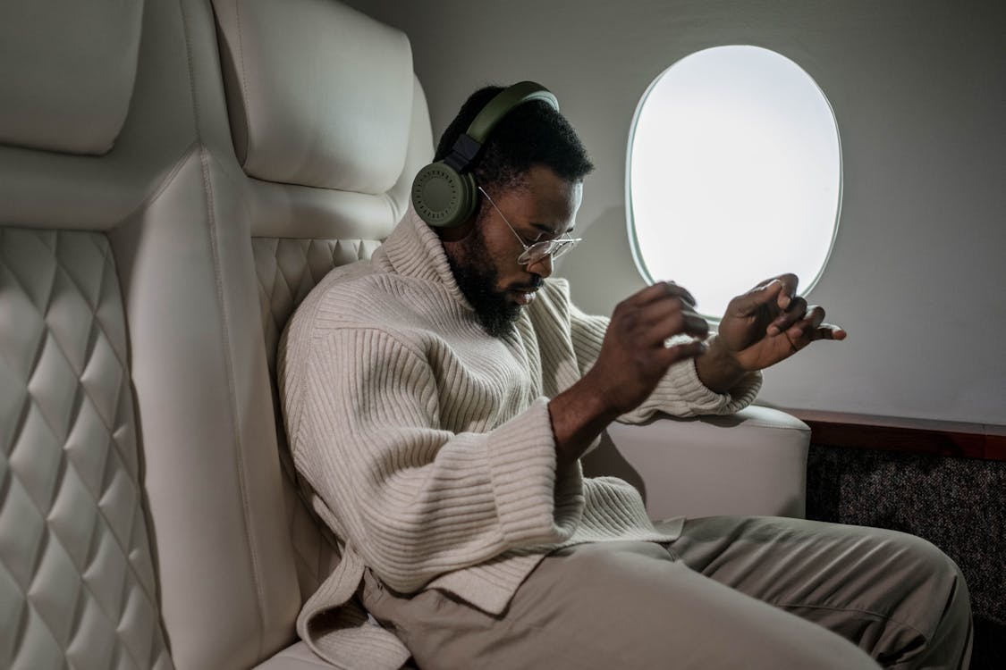 Free Man Listening To Music While Inside A Airplane Stock Photo