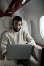 Man Using his Laptop While Inside an Airplane