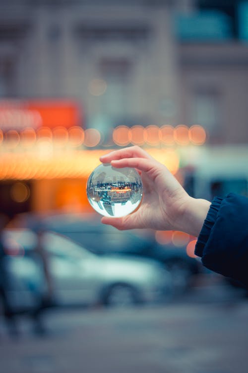 Free Person Holding Round Glass Ball Macro Shot Stock Photo
