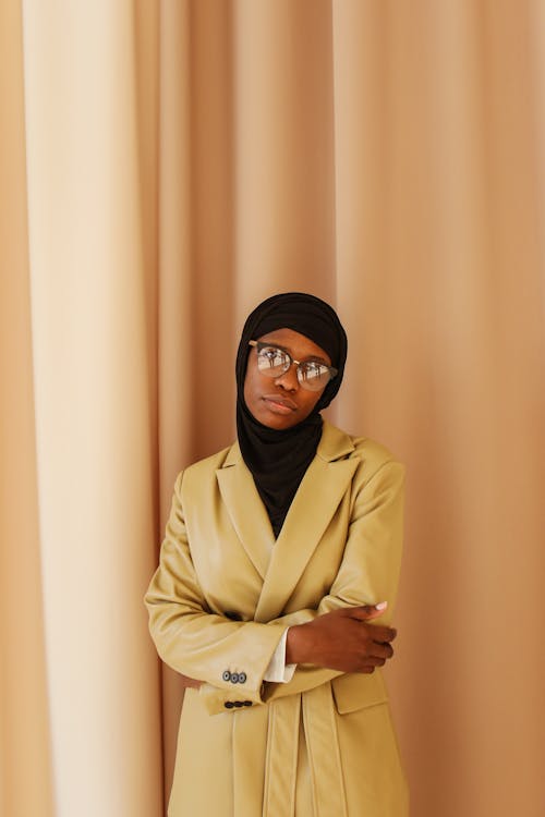 Woman With Black Hijab Standing Near A Curtain With Arms Crossed