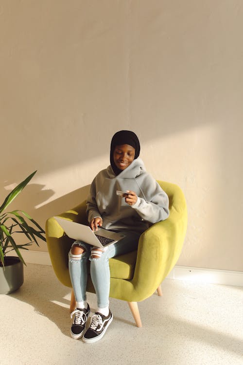 Kostnadsfri bild av afrikansk amerikan kvinna, bärbar dator, håller